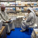 Attendees read books at a stall during the Abu Dhabi International Book Fair at ADNEC on Monday. The fair, which has been running since 1981, features more than 1,400 exhibitors from 96 countries. (Fadel Senna / AFP via Getty Images)