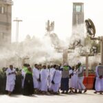 Pilgrims in Mecca shelter from the heat under giant fans blowing a cool mist, one of the measures Saudi Arabia has taken to protect pedestrians from heat as the Hajj Pilgrimage approaches. A newly opened walkway also includes heat-reducing plastic surfaces, lighting and rest areas with mobile phone charging stations. (Esra Hacioglu/Anadolu via Getty Images)