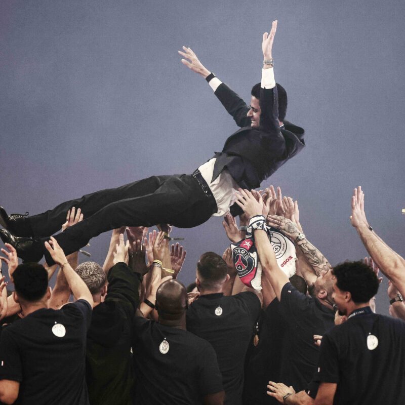 Players lift Paris Saint Germain's Qatari president Nasser al-Khelaifi up in the air as they celebrate during a trophy ceremony a day after the football club won the UEFA Champions League, at the Parc des Princes Stadium in Paris on Sunday. (Thibaud Moritz AFP via Getty Images)