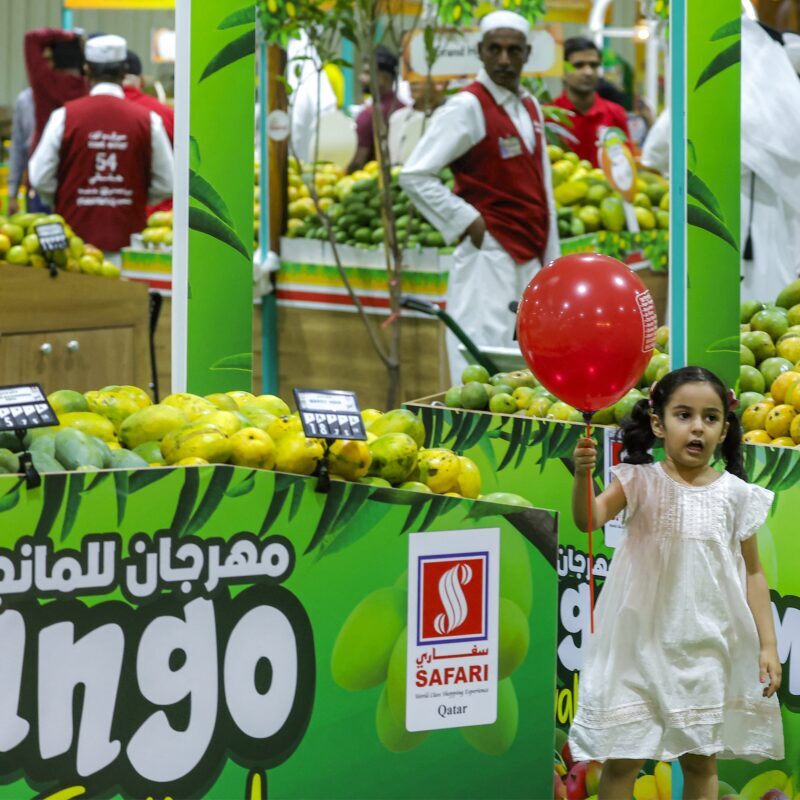 A girl walks past stalls during the Indian Mango Festival at Souq Waqif in Doha on Thursday. Gulf countries are among the biggest importers of Indian mangoes, which are in peak season from June to July. (Karim Jaafar / AFP via Getty Images)