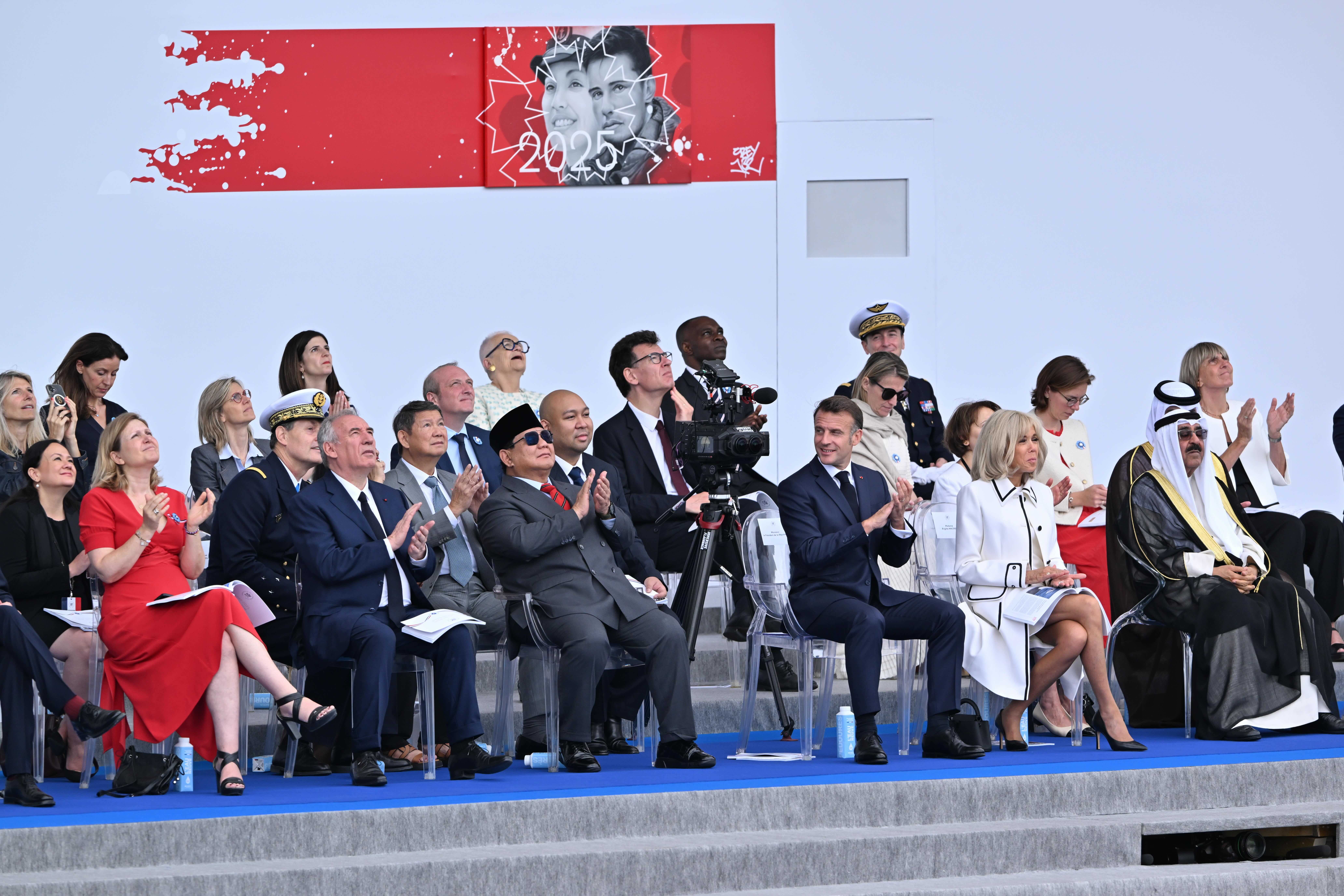 Emir of Kuwait Mishal Al-Ahmad Al-Jaber Al-Sabah (right) and Indonesian President Prabowo Subianto were among the foreign dignitaries who joined French President Emmanuel Macron and his wife Brigitte to watch the annual Bastille Day military parade on the Champs-Elysees Avenue in Paris on July 14. (Mustafa Yalcin/Anadolu via Getty Images)