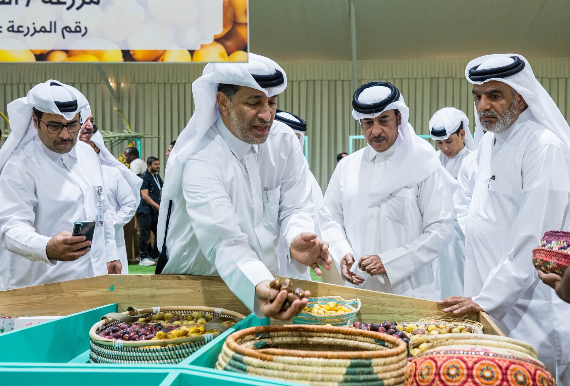 Attendees examine fresh dates at the 10th edition of the Local Dates Festival at Souq Waqif traditional market in Doha, Qatar, on Thursday. The festival includes produce from more than 100 date farms in Qatar. (Noushad Thekkayil/NurPhoto via Getty Images)